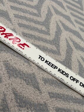 White Promotional Ruler with Red Logo and Black Text dare